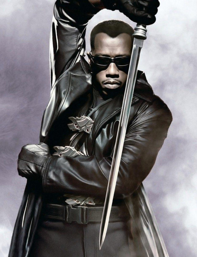 Wesley Snipes as the character Blade, known for his iconic black leather trench coat and specialized vampire-hunting sword