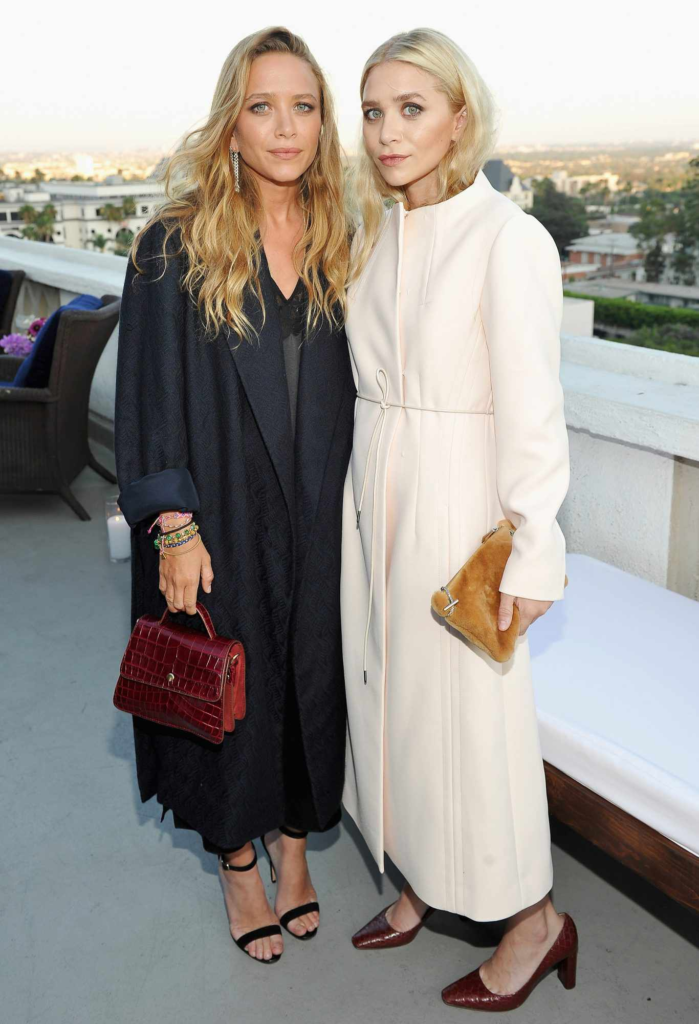 Mary-Kate and Ashley Olsen are shown wearing The Row designs at the Elizabeth and James store opening party in Los Angeles