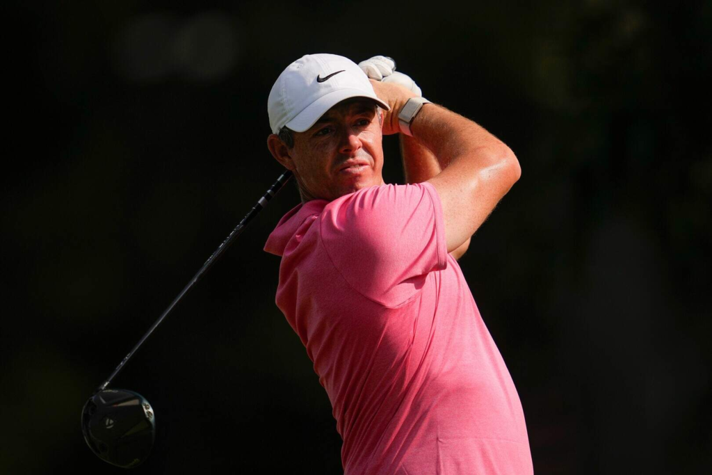 Rory McIlroy swinging a driver on the course