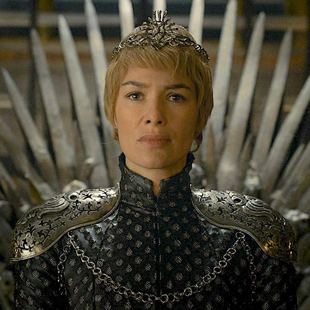 Lena Headey as Queen Cersei Lannister wearing her iconic silver-embossed coronation gown and crown in the fantasy series Game of Thrones