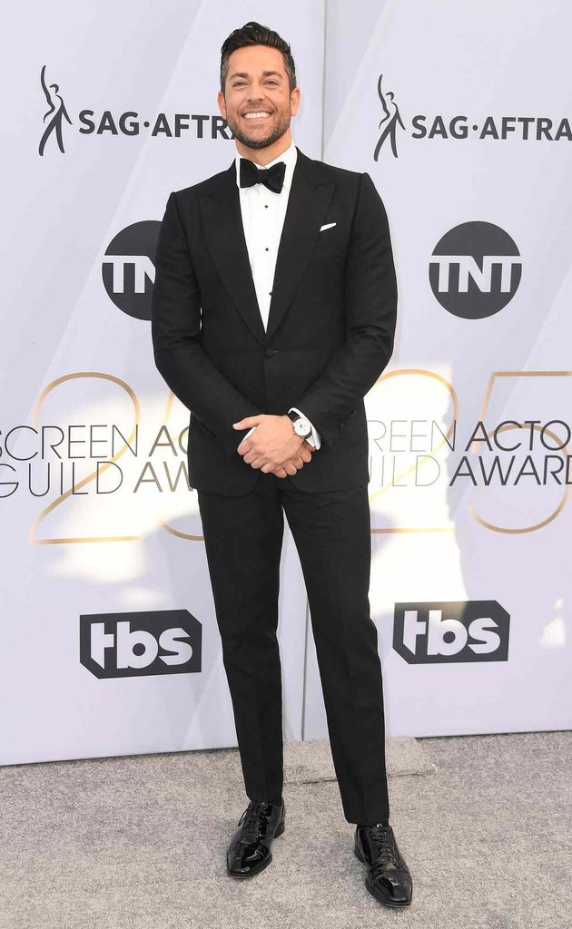 Zachary Levi wears a sharp black dunhill tuxedo paired with a classic bow tie and a Montblanc wristwatch on the red carpet at the 25th Annual Screen Actors Guild Awards in Los Angeles