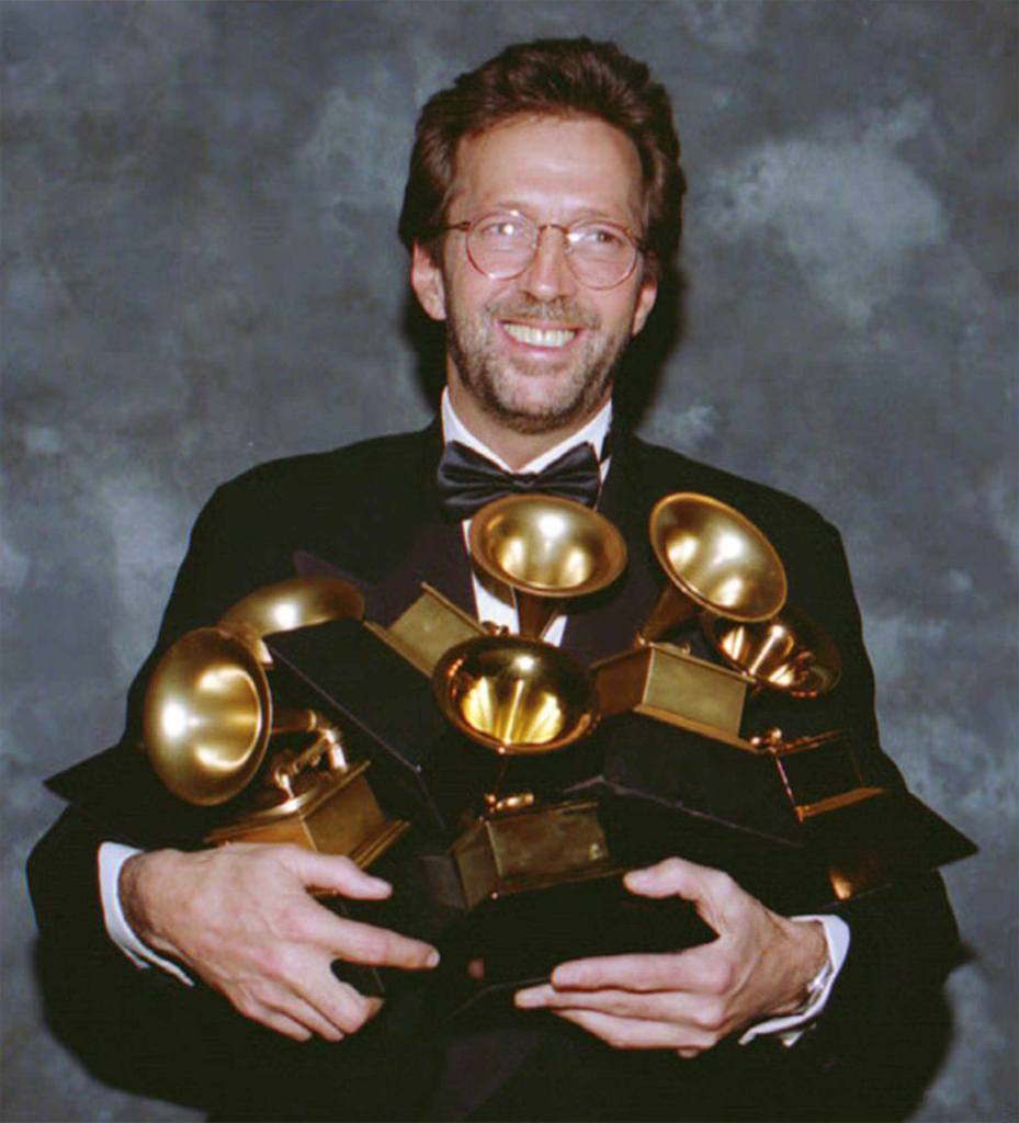 Eric Clapton holding six Grammy awards at the 35th Annual Grammy Awards in 1993