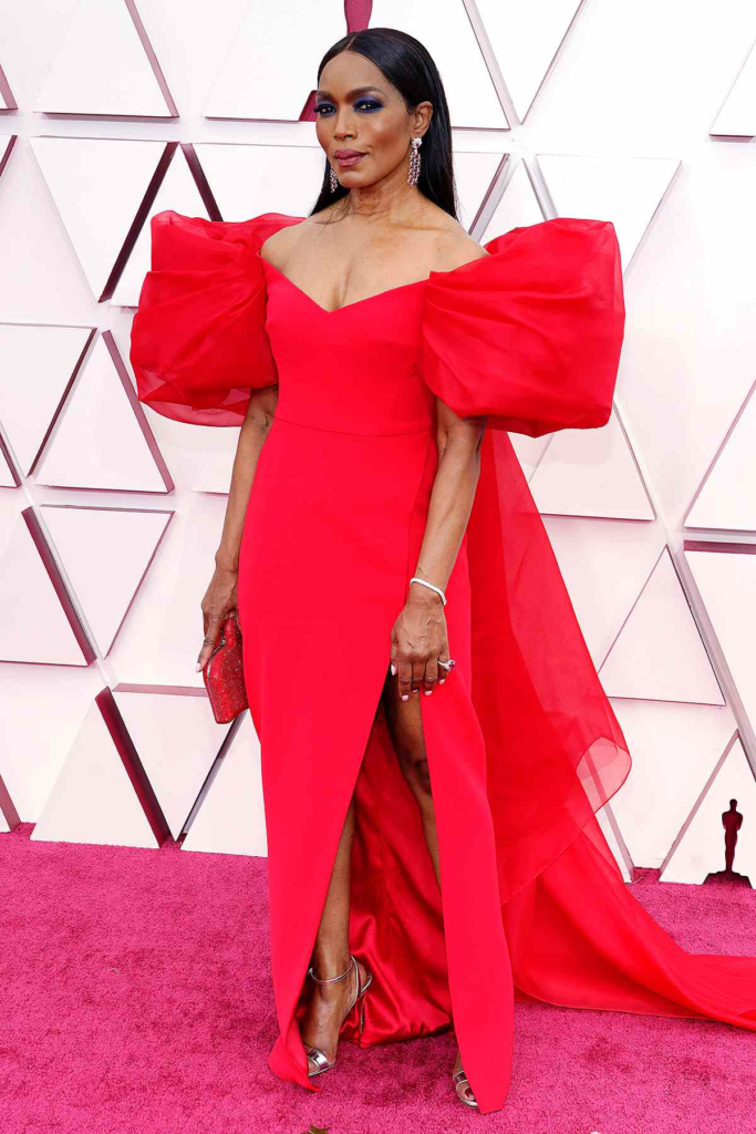 Angela Bassett attended the 2021 Oscars wearing a custom red Alberta Ferretti gown featuring dramatic puff sleeves and a high slit