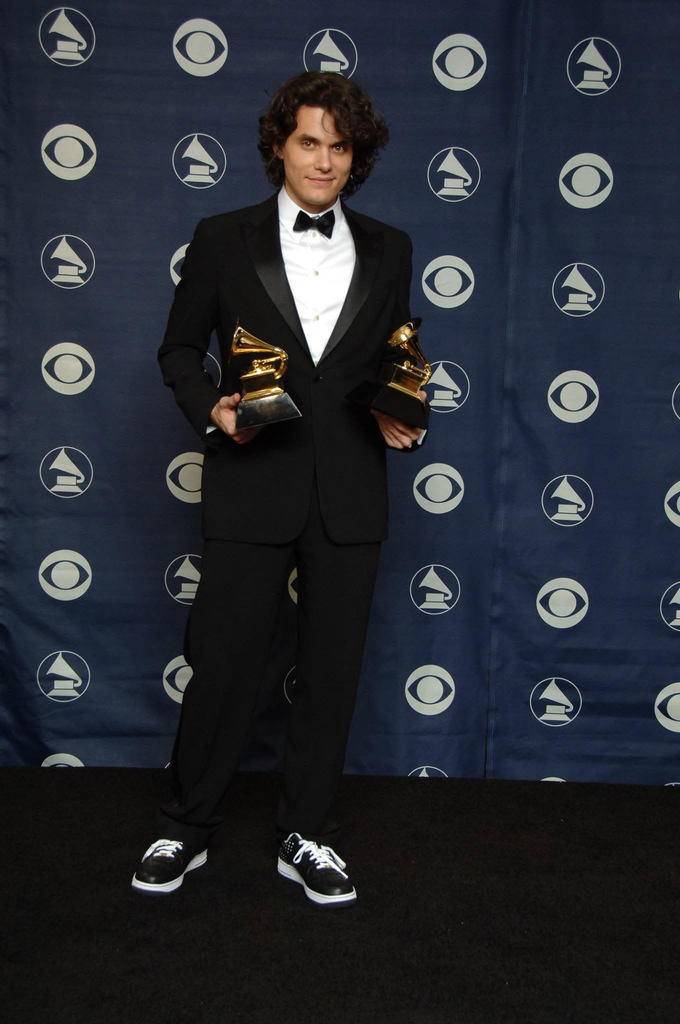 John Mayer posing with two Grammy Awards backstage at the 49th Annual Grammy Awards in 2007