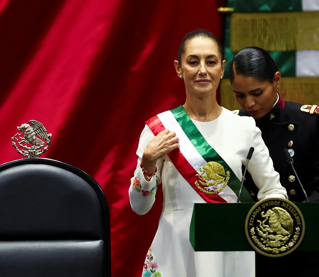Claudia Sheinbaum receiving the presidential sash during her swearing-in ceremony as the first female president of Mexico on October 1, 2024