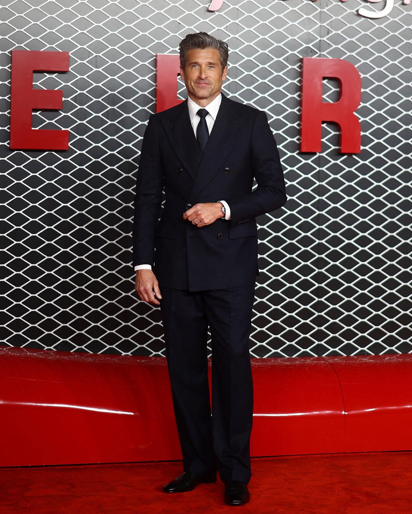American actor Patrick Dempsey attending a red-carpet premiere in a classic dark double-breasted suit