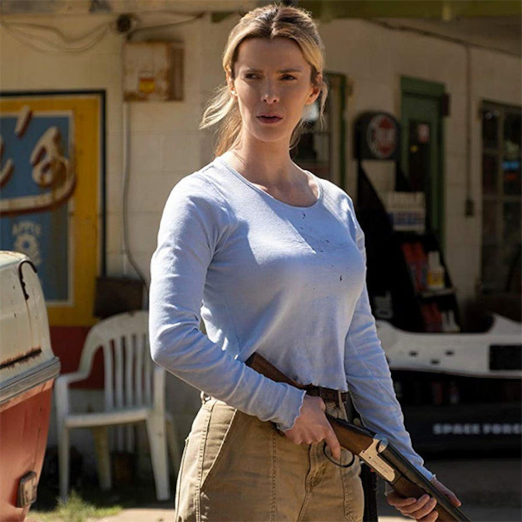 Betty Gilpin as Crystal Creasey holding a shotgun in the 2020 satirical thriller movie The Hunt