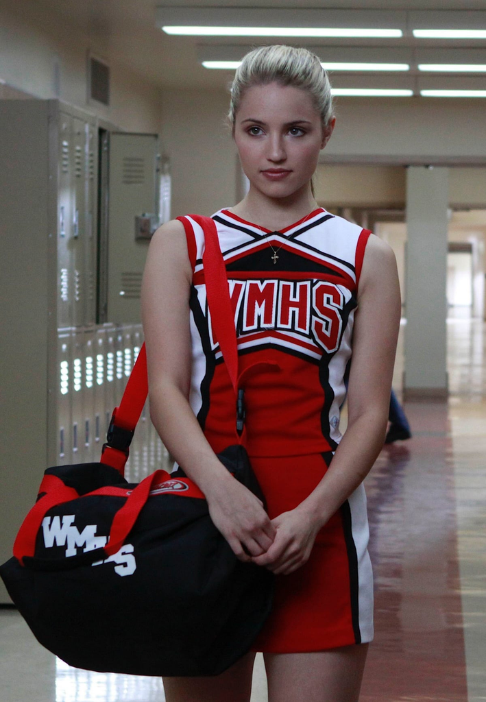 Dianna Agron as Quinn Fabray wearing a red and white McKinley High cheerleader uniform from the TV show Glee