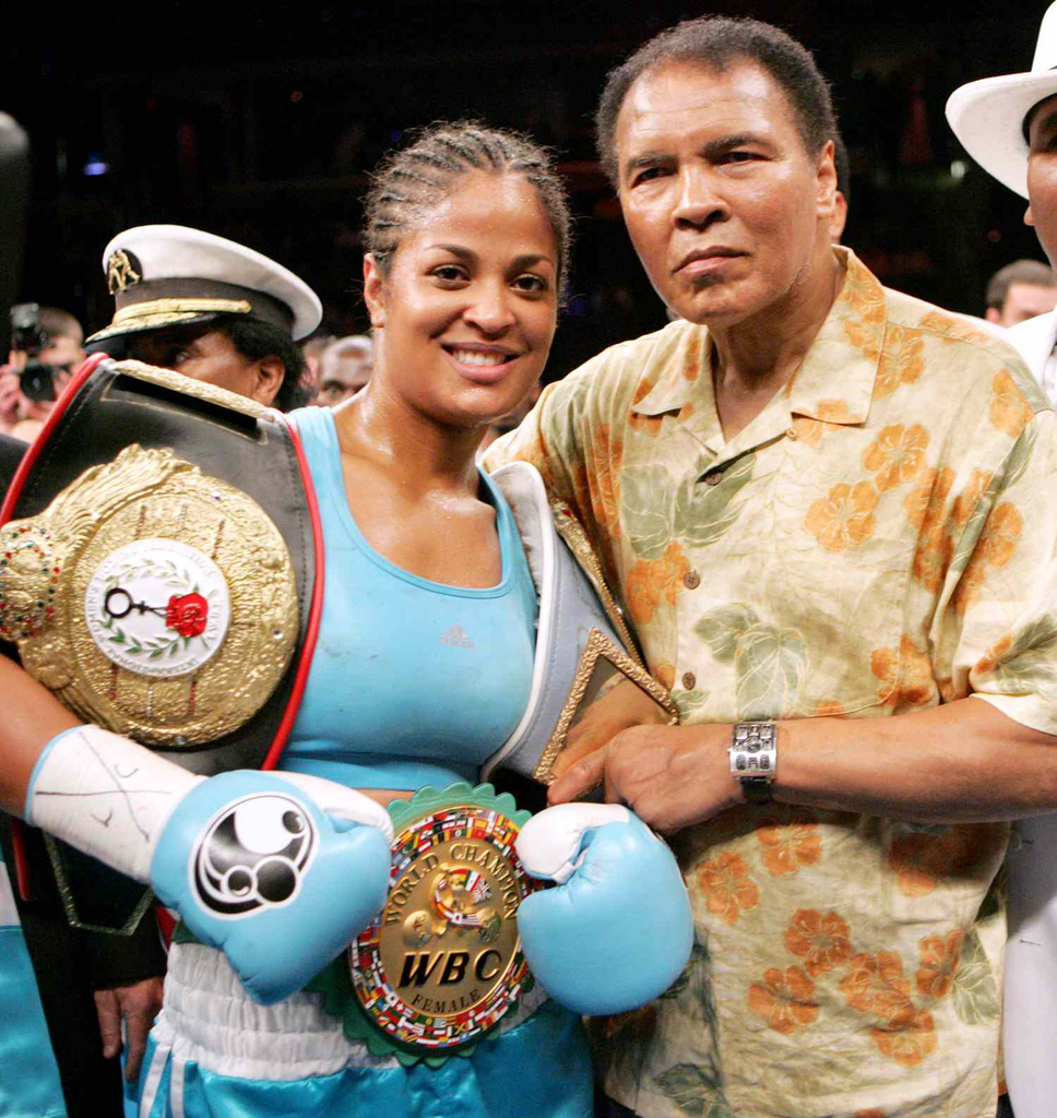 retired undefeated professional boxer Laila Ali posing with her father, the legendary heavyweight champion Muhammad Ali