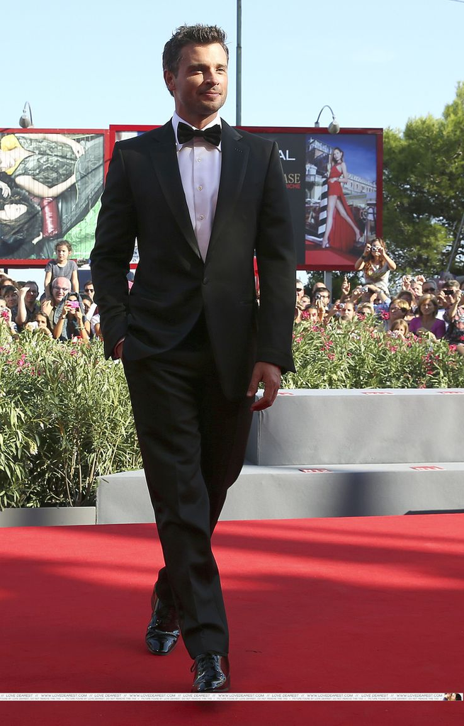 Actor Tom Welling walks the red carpet in a black tuxedo at the premiere of Parkland during the 70th Venice International Film Festival on September 1, 2013