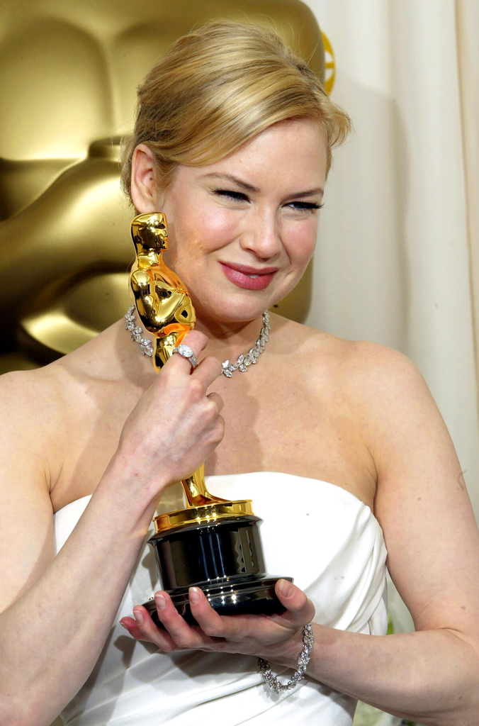 Actress Renée Zellweger holds her Academy Award backstage after winning Best Supporting Actress for Cold Mountain at the 76th Academy Awards on February 29, 2004