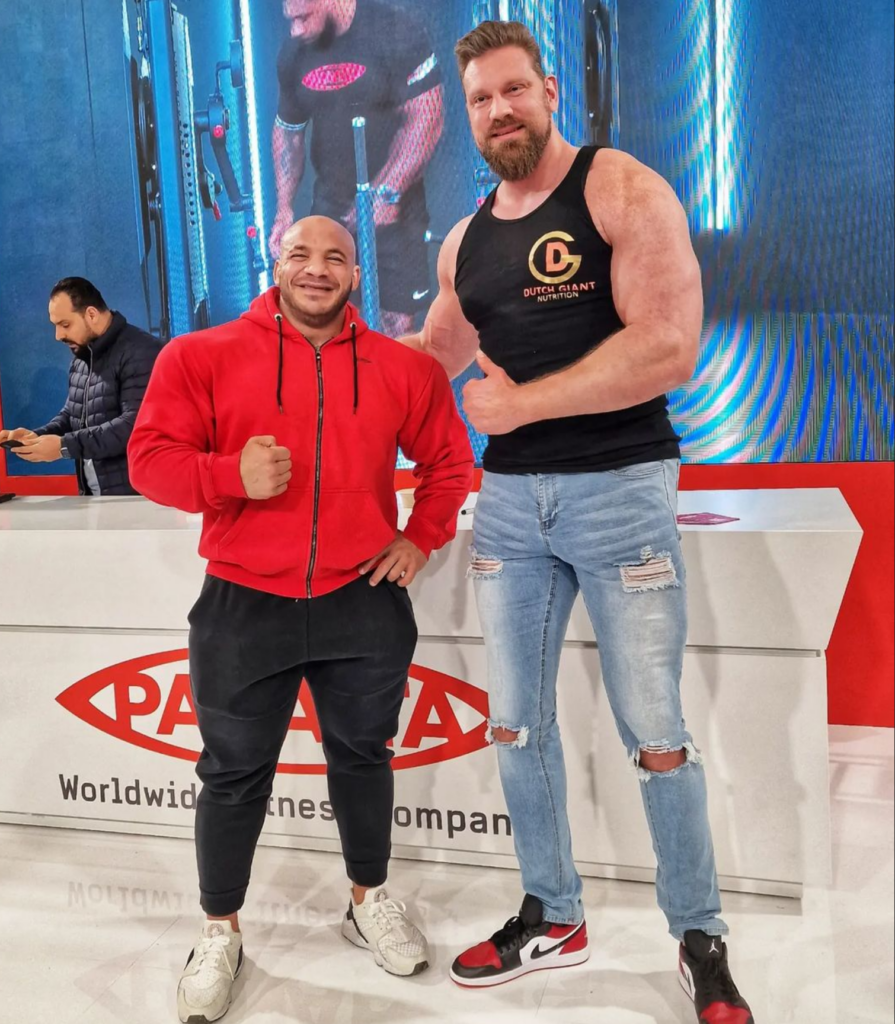 Dutch actor and bodybuilder Olivier Richters (known as "The Dutch Giant," standing 2.18 m / 7'2" tall) posing next to Egyptian former Mr. Olympia champion Mamdouh "Big Ramy" Elssbiay (standing about 1.78 m / 5'11" tall) at the FIBO fitness expo