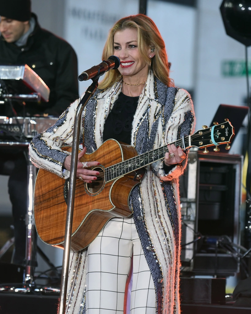 American country singer Faith Hill performs live on stage with an acoustic guitar