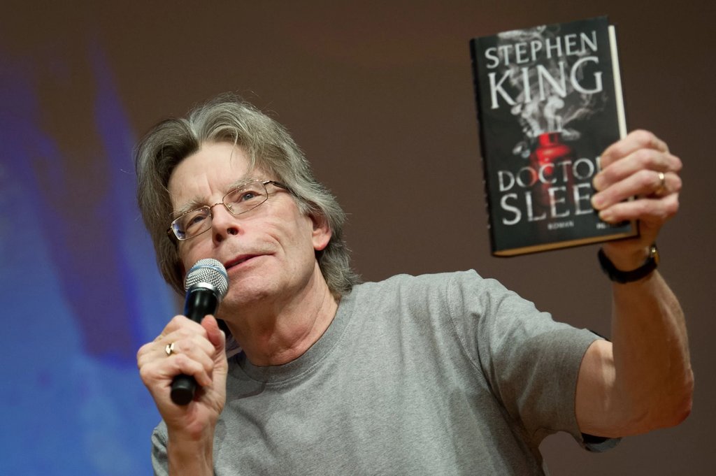 Author Stephen King holds up a copy of his novel Doctor Sleep during a promotional reading event in Hamburg, Germany, on November 20, 2013
