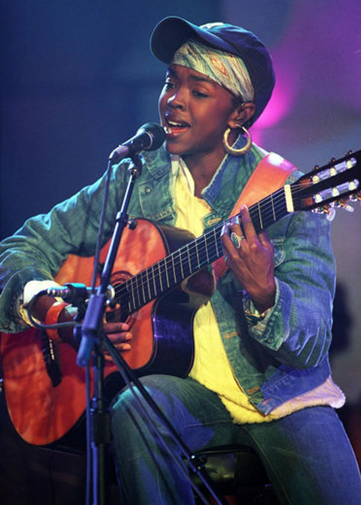 Lauryn Hill performing live with an acoustic guitar during her recording of MTV Unplugged No. 2.0 at MTV Studios in Times Square, New York City, on July 21, 2001